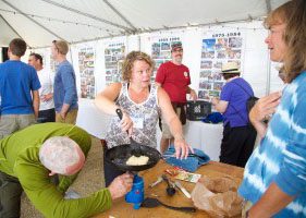 Chris Young, or "Yuma" (red shirt) watches as Mountaineering alumni prepare a feast worthy of a campout during the 60th Reunion in August.