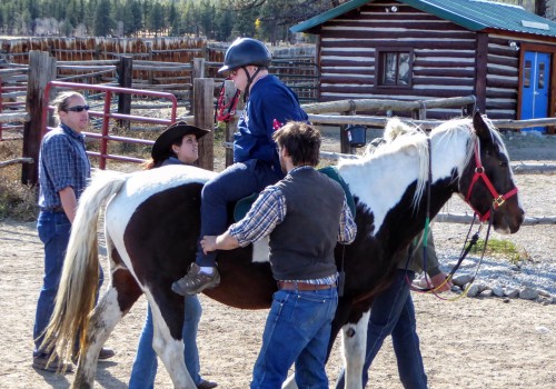 Riding backwards on a horse, like this RVRN participant, is a significant exercise in trust that takes place at 100 Elk.